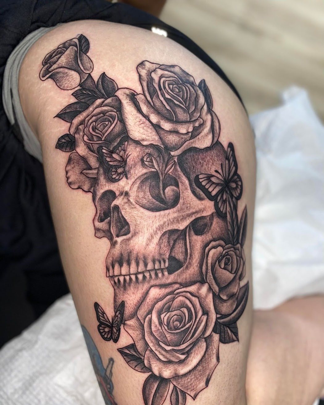 Black and grey skull and roses tattoo